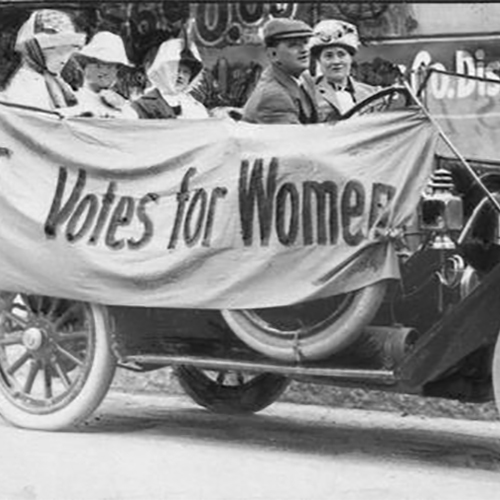 Members of the Political Equality League in an early Ford automobile draped with bunting reading 'Votes for Women.'' In the front seat is Mrs. B.C. Gudden. In the back seat, left to right, are Ruth Fitch, Bertha Pratt King, and Helen Mann.